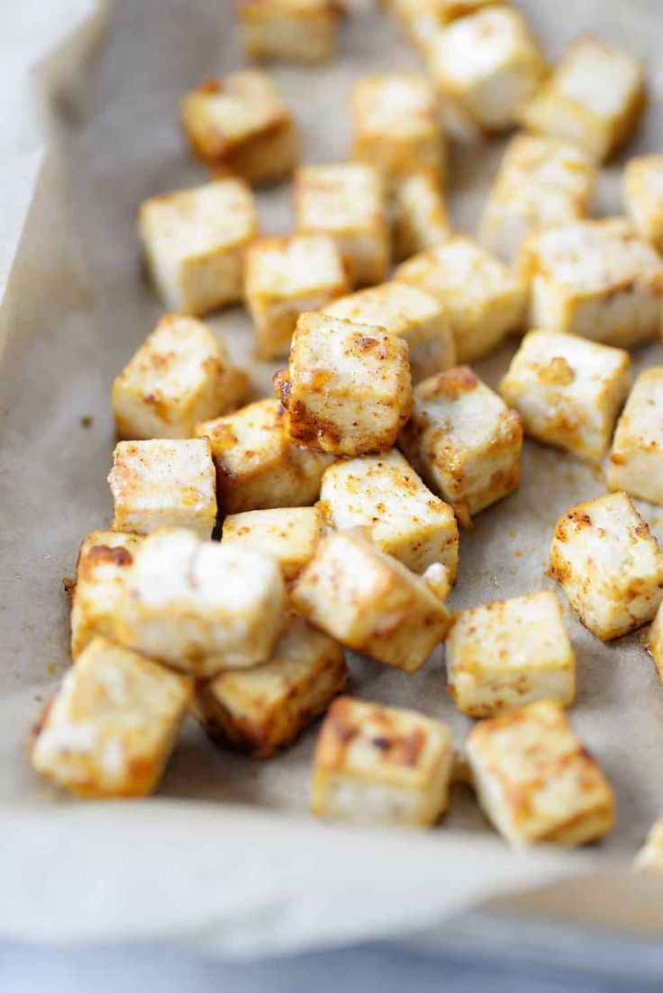 tofu cubes on a baking sheet ready to be cooked in the oven for dinner