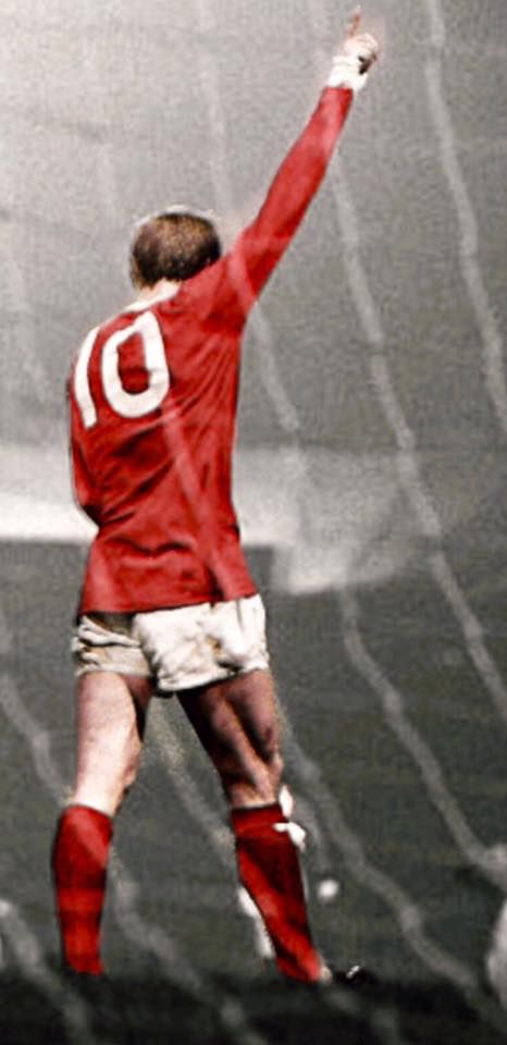 a man in red and white uniform reaching up to catch a soccer ball