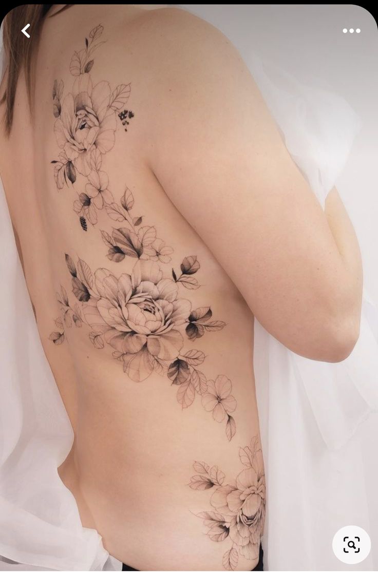 a woman's back with flowers on it