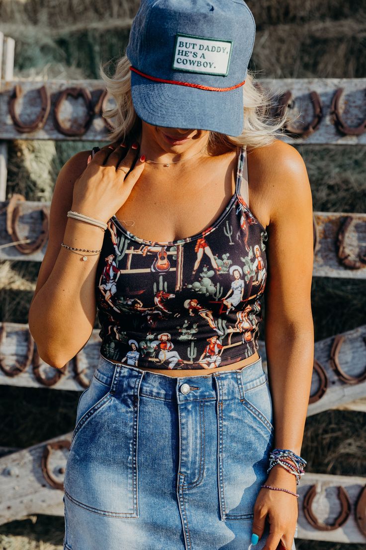 Get ready to wrangle some compliments in our Pinup Cowgirl Top! This vintage-inspired tank features playful cowgirl graphics and stretchy spaghetti straps for a snug fit. With a cropped length, this black western tank top will add a touch of sass to any outfit. Kiah is wearing size small paired with The Shanelle Skirt, But Daddy, Trucker, The Paisley Vest and Ariat Casanova Boots Western Tank Tops, Curvy Dress, Bottoms Pants, Cotton Shirt, Sweater Top, Spaghetti Strap, Clothes For Sale, Pin Up, Jumpsuit Romper