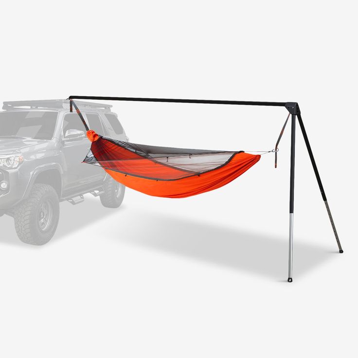 an orange hammock attached to the back of a pickup truck in front of a white background