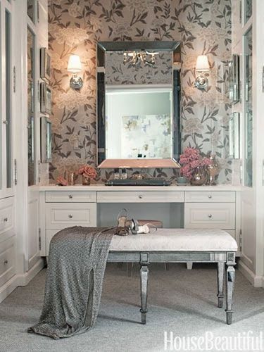 a bathroom with a bench, mirror and lights on the wall next to the sink