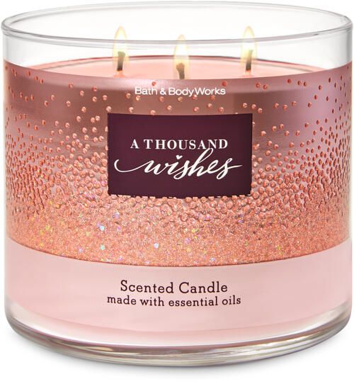 a pink candle that is sitting in front of a white background with the words, a thousand