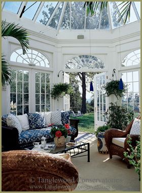 a living room filled with furniture and lots of windows