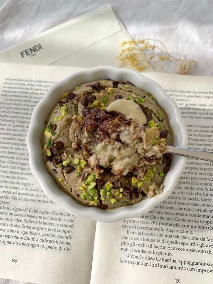 a bowl of food sitting on top of an open book