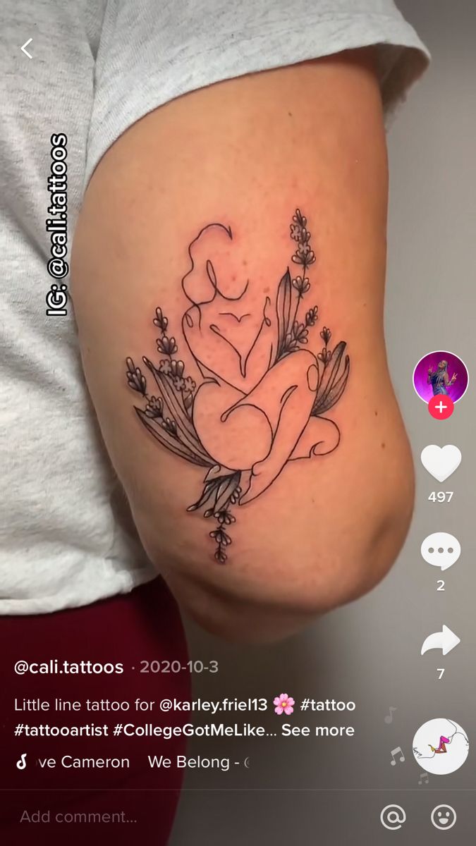 a woman's stomach with tattoos on it and flowers in the middle of her abdomen