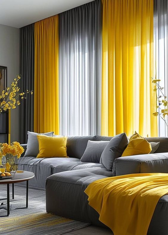 a living room with yellow curtains and gray couches