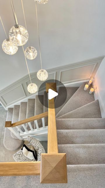 an overhead view of a staircase with chandeliers hanging from it's ceiling