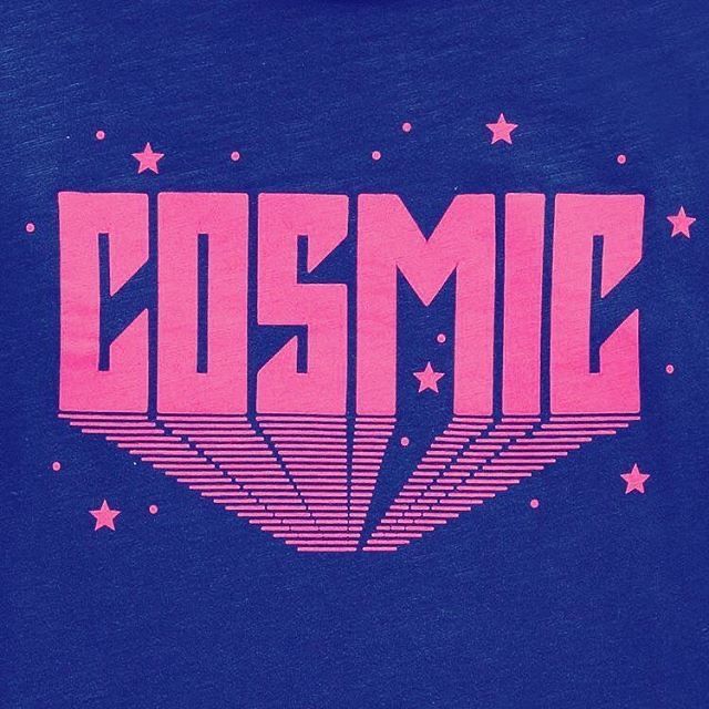 the back of a blue shirt with pink letters and stars on it