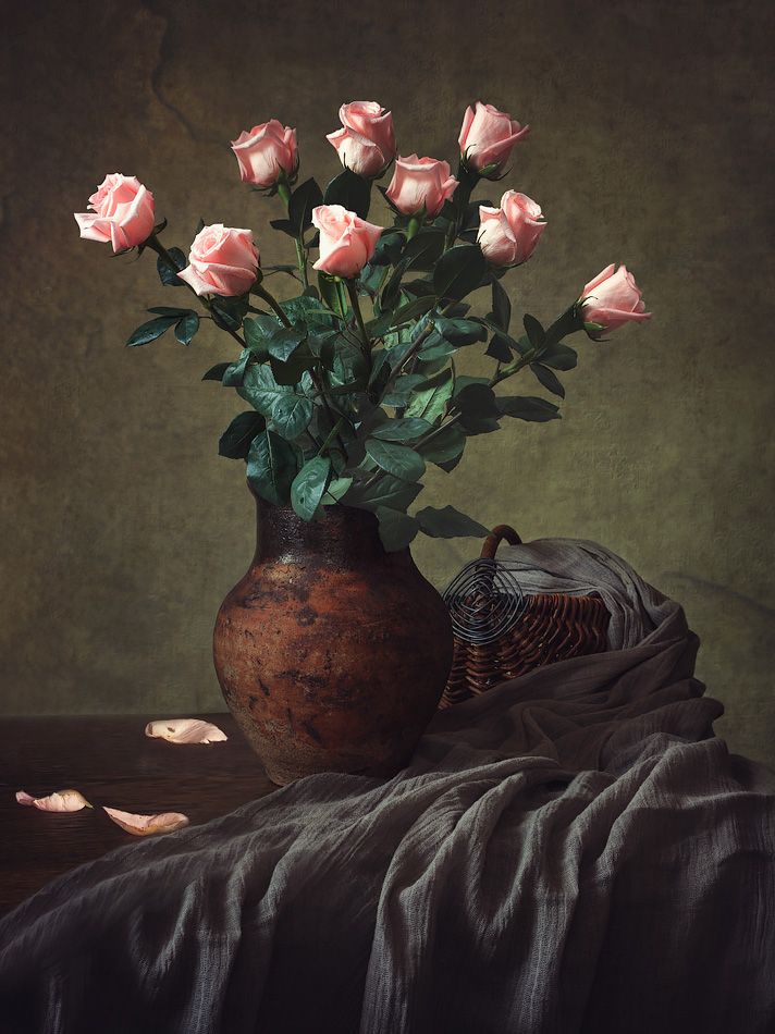 a vase filled with pink roses on top of a table