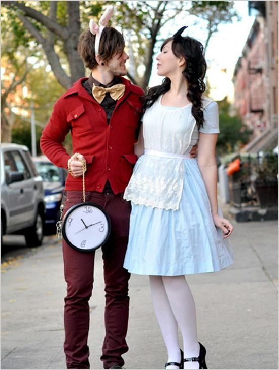 a man and woman dressed up as alice and the mad hatter on a city street