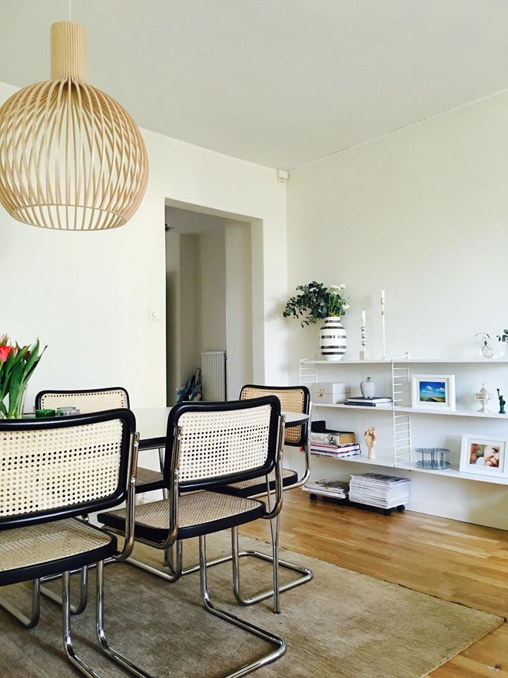 two chairs and a table in a room with wood floors, white walls and flooring