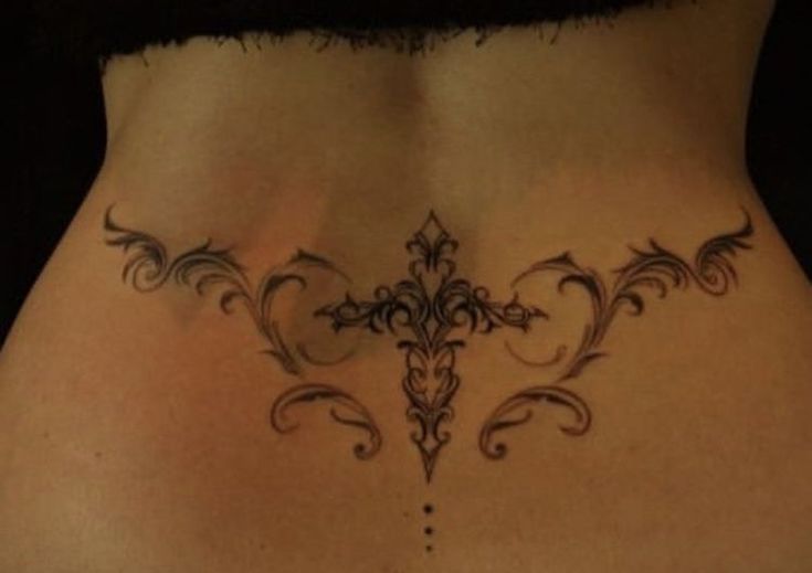 a woman's stomach with an ornate design on the side and lower back piece