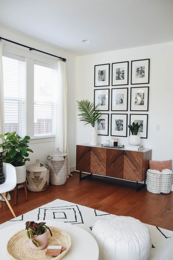 a living room filled with furniture and pictures on the wall