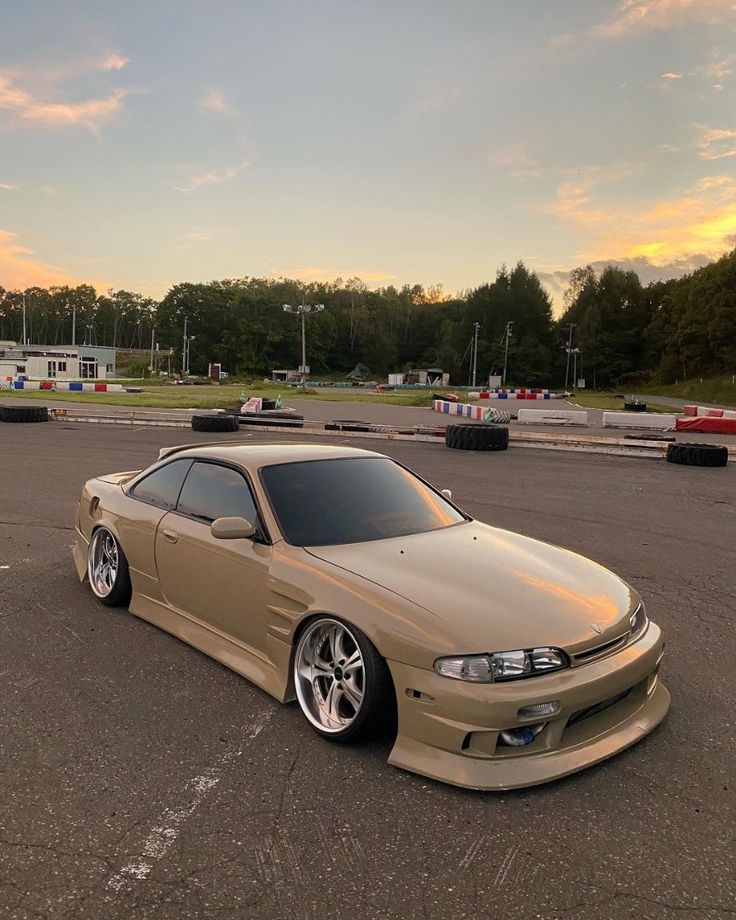 a tan car parked in a parking lot