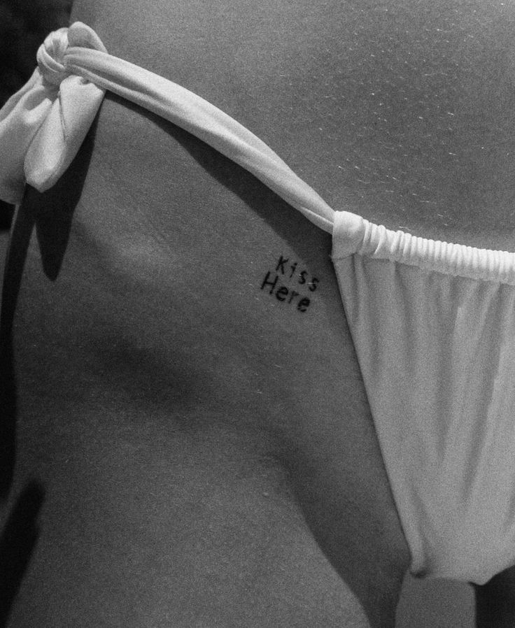 black and white photograph of the back of a woman's stomach with her name written on it