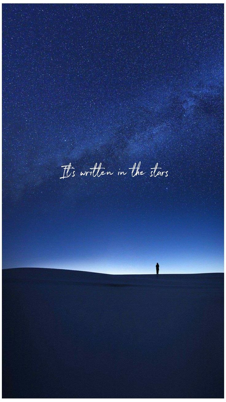 a person standing in the middle of a field under a night sky with stars above