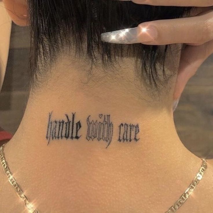 a woman with a tattoo on her neck that says handle society care written in cursive font