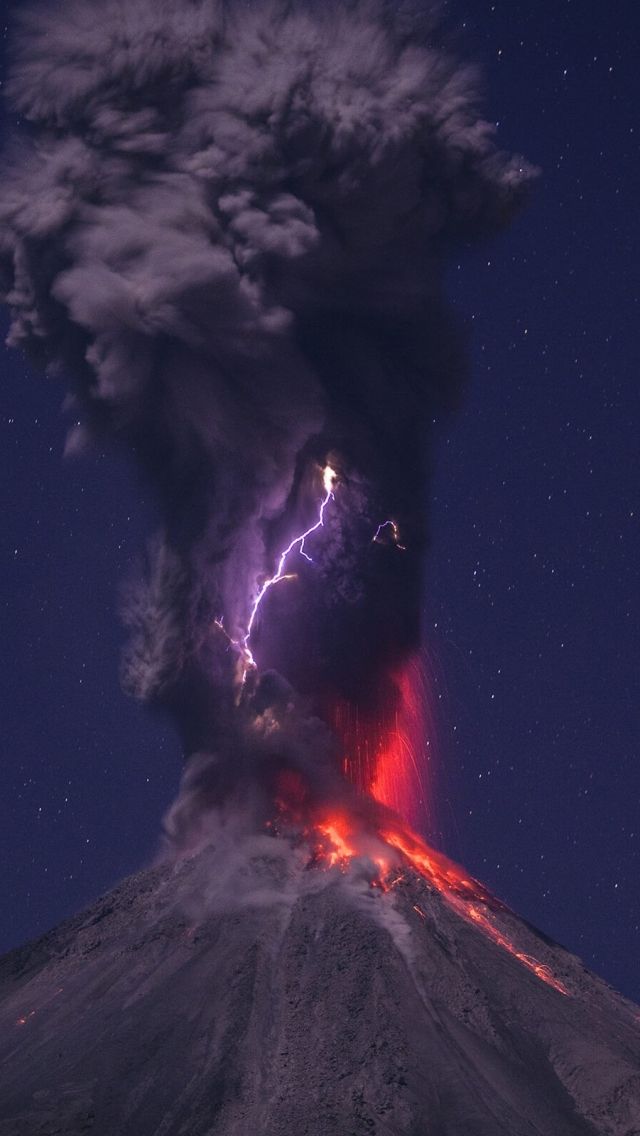 an image of a volcano with lightning in the sky