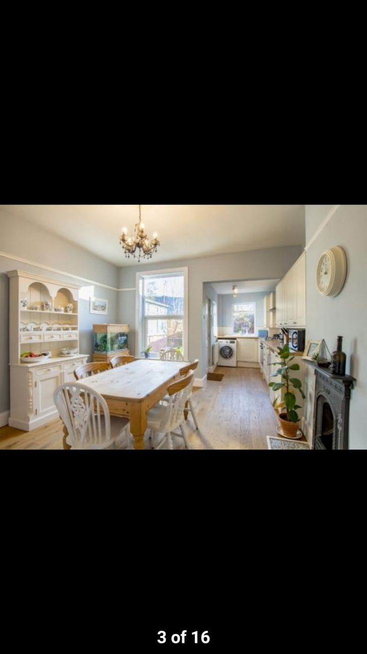 a dining room table and chairs in front of a fireplace