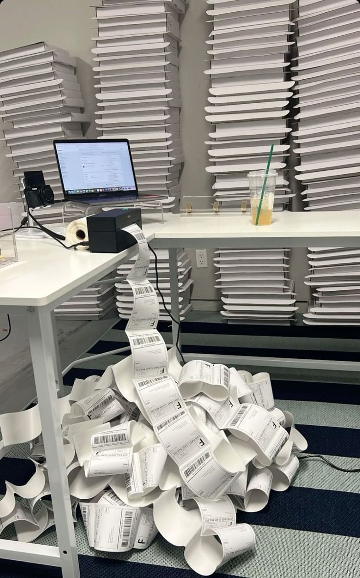 a pile of papers sitting on the floor next to a desk