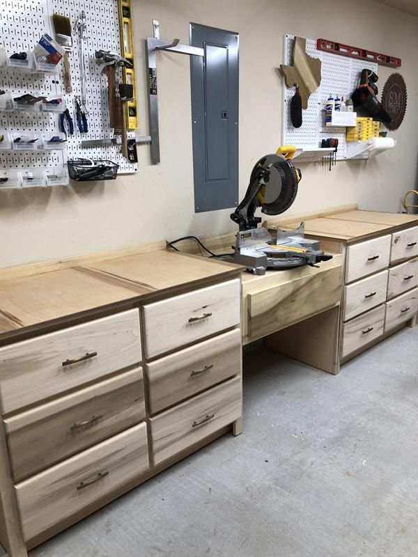 a workbench with many drawers and tools on it