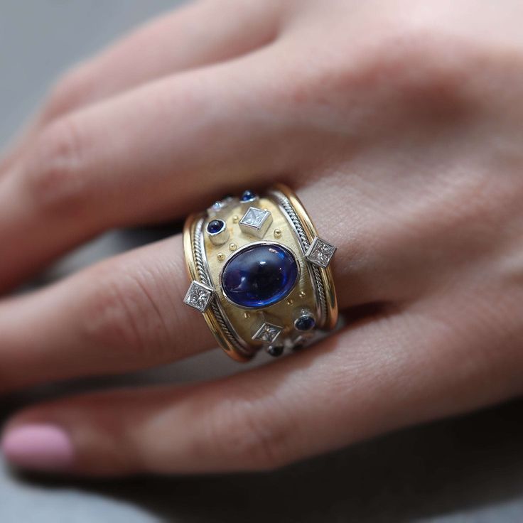 Remarkable one-of-a-kind Royal Blue Ceylon Sapphire ring, hand-crafted in the signature style of the Archeological Revival. Unisex.Size 5, can be adjusted upon request. 3.32 Oval Cabochon Sapphire 1.16ct eight Princess Cut G color, VS2 diamonds 1.14ct six Round Cabochon Sapphires 18k yellow gold platinum If you have any questions regarding this piece, contact us. Royal Blue Sapphire Ring, Fine Jewelry Rings, Ceylon Sapphire Ring, Royal Rings, Pink Opal Ring, Silver Gold Necklace, Emerald Diamond Earrings, Jewelry Knowledge, Fancy Yellow Diamond