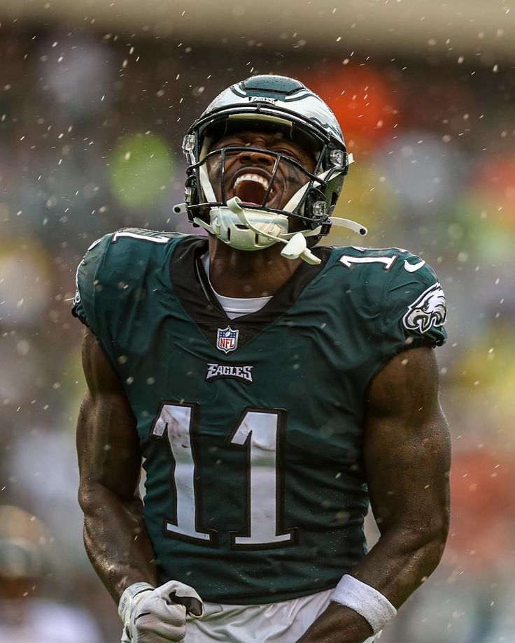 a close up of a football player in the rain