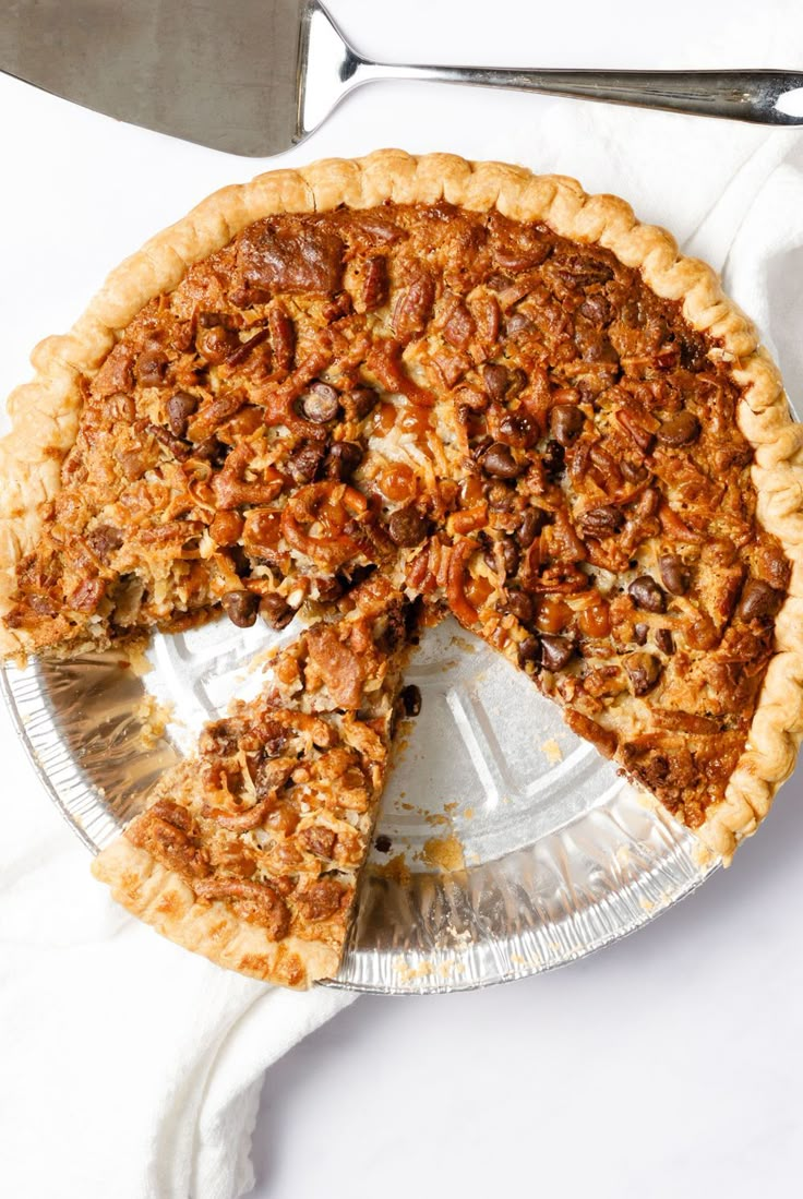 a pecan pie with one slice missing from it