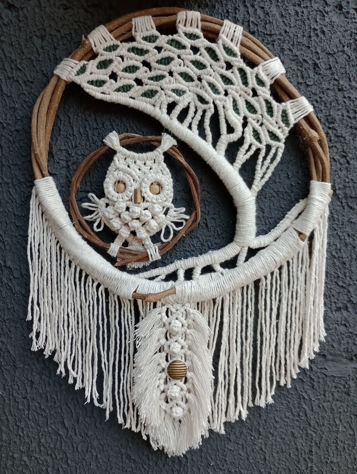 an owl dream catcher hanging on the wall