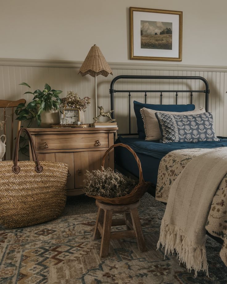 a bed room with a neatly made bed and a basket on the floor next to it