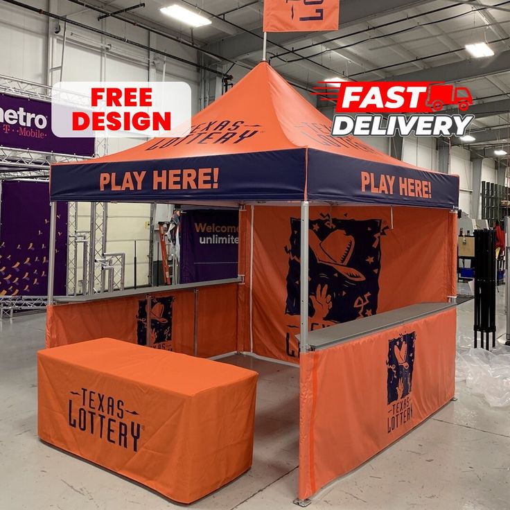 an orange and blue tent with the words fast delivery on it in front of other signs