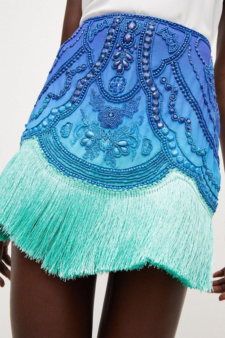 Borrowing From The Art Deco Era, This Opulently Beaded Ombre Mini Skirt Blends Swishy Tassels With A High-Rise Fit And Undeniably Glamorous Vibe. The Tassels Come Cut In A Draped, Asymmetric Line, Giving This High-Voltage Piece A Beautiful Sense Of Movement.Style: Skirtdesign: Embroideredfabric: Wovenlength: Mini Beaded Fringe Skirt, Fringe On Clothes, Beaded Mini Skirt, Bohemian Party Bottoms With Tassels, Spring Party Mini Skirt With Rhinestone Fringe, Embellished Evening Skirt For Summer, Summer Mini Skirt With Tassels, Bohemian Fringe Mini Skirt For Summer, Elegant Summer Skirt With Tassels