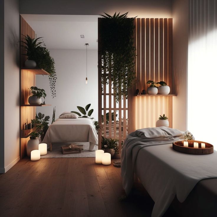 a spa room with candles lit up on the floor and a bed in the middle