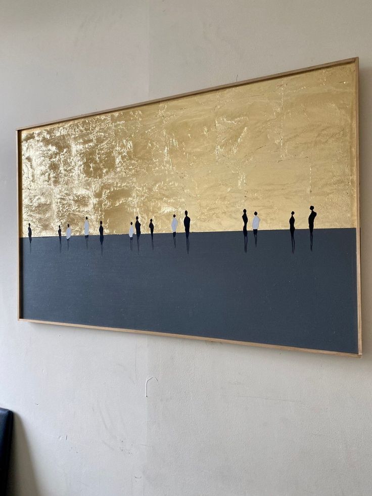 a painting hanging on the wall with people walking in front of it and one person holding a surfboard