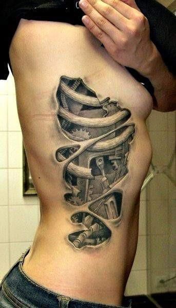 a man's back with a tattoo on his stomach and an image of a machine