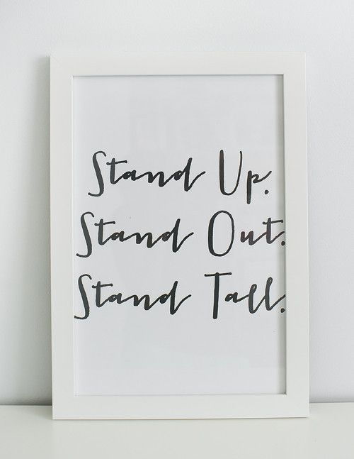 a black and white photo with the words stand up, stand out, stand tall