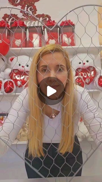 a woman standing in front of a fence with teddy bears behind her and the caption says, i love you