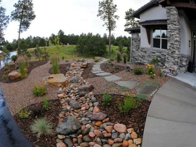 a house with rocks and gravel in front of it