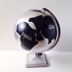 a black and white globe with the word africa on it sitting on a metal stand