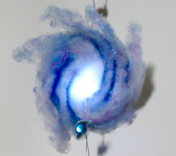 a blue and white spinning object on a string