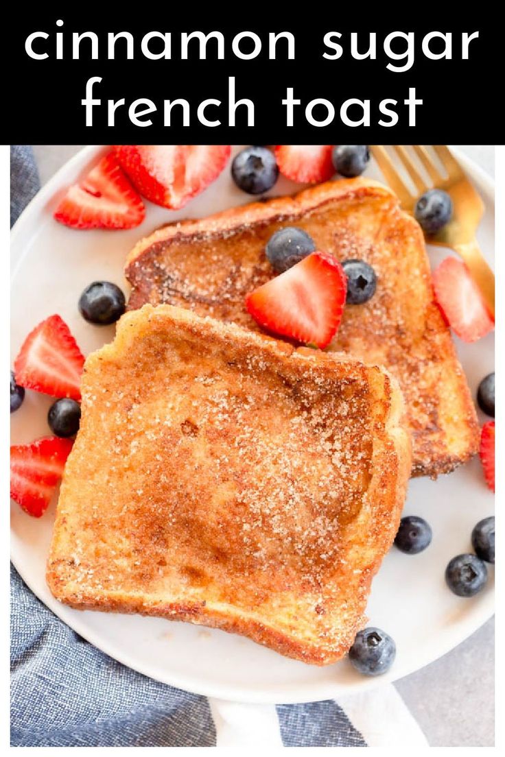 french toast topped with strawberries and blueberries on a white plate