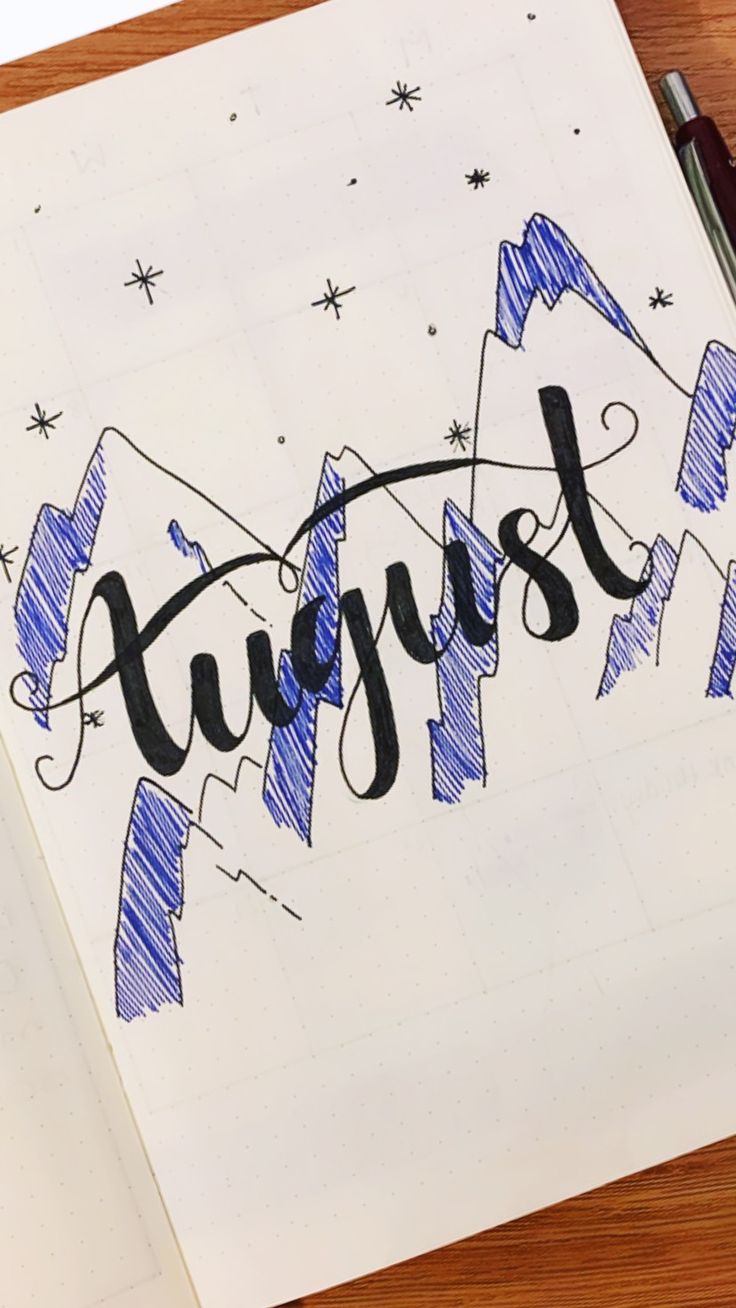 a notebook with the word august written in cursive writing on top of it