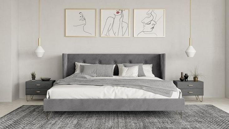 a large bed sitting in a bedroom next to two pictures on the wall above it