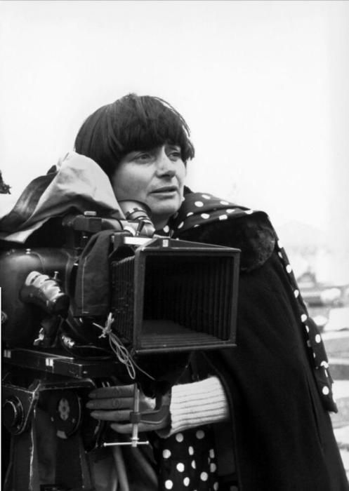 black and white photograph of a woman holding a camera