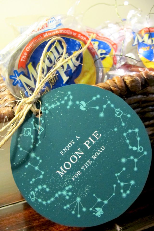 a basket filled with cookies and snacks on top of a wooden table next to a sign that says moon rise