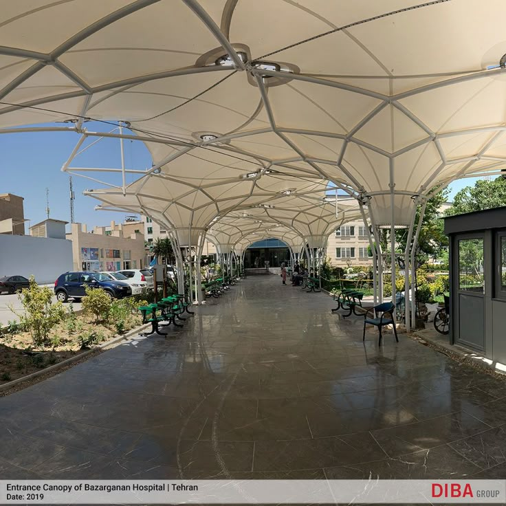 an outdoor covered walkway with tables and chairs