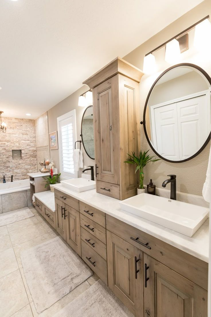 a large bathroom with double sinks and mirrors