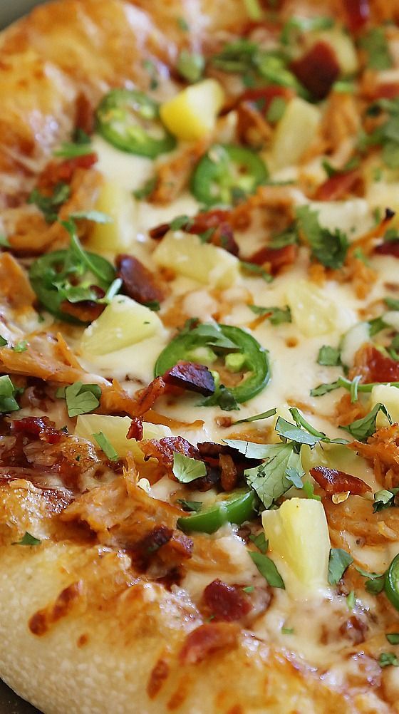 a pizza with pineapple, bacon and green peppers