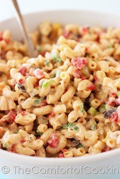 macaroni and cheese with colorful toppings in a bowl